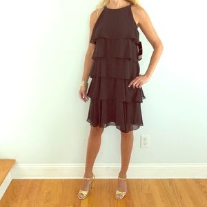 Black tiered cocktail dress with beaded straps.